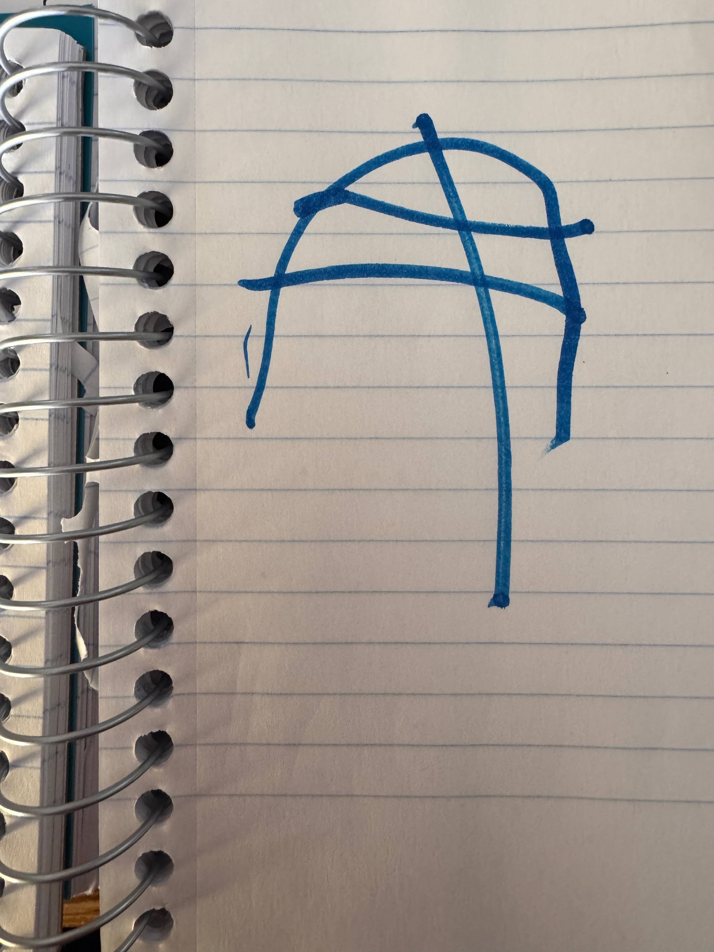 A little kid drawing on lined notebook paper