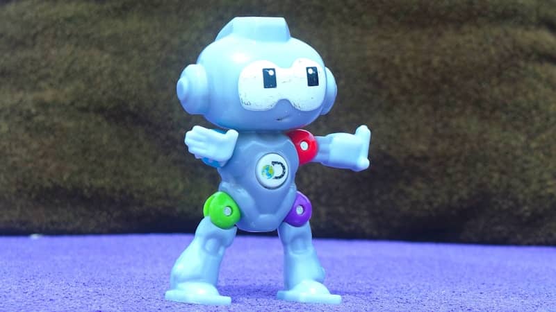 A blue robot toy stands up.