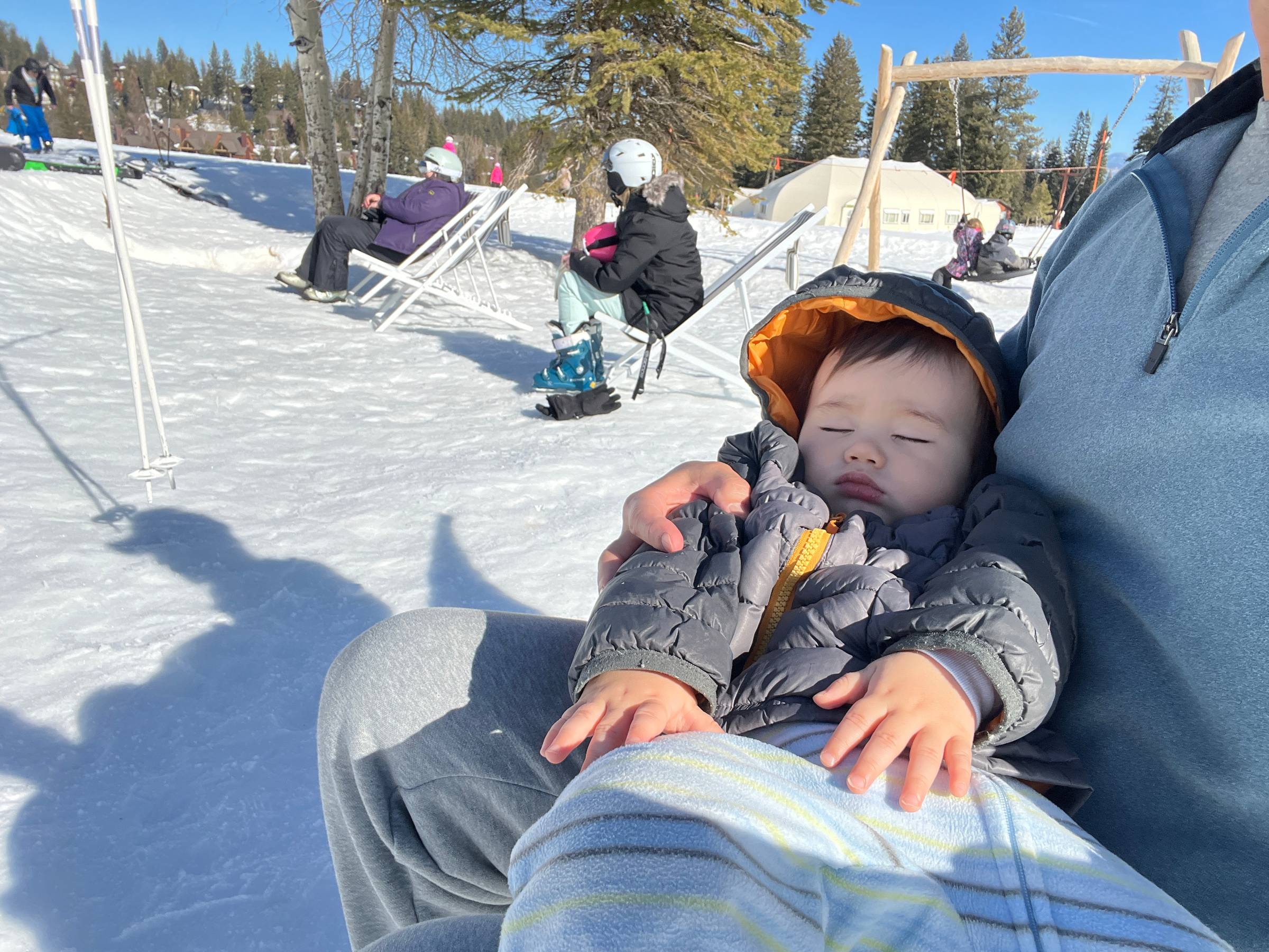 A sweet sleeping baby on the ski hill