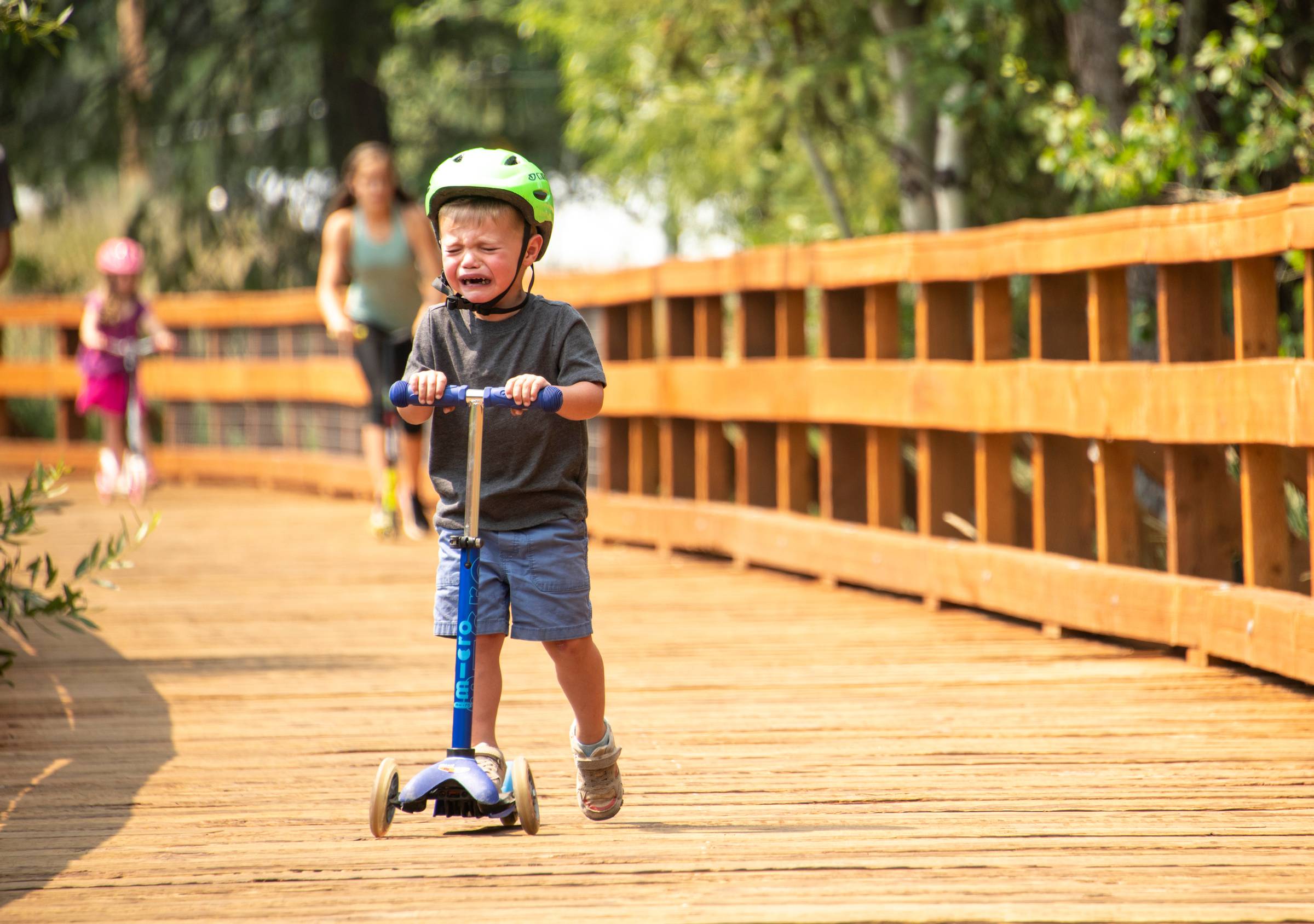 Kid crying on a scooter