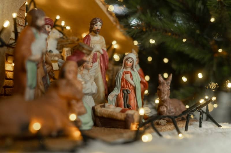 Christmas nativity scene with figurines and lights