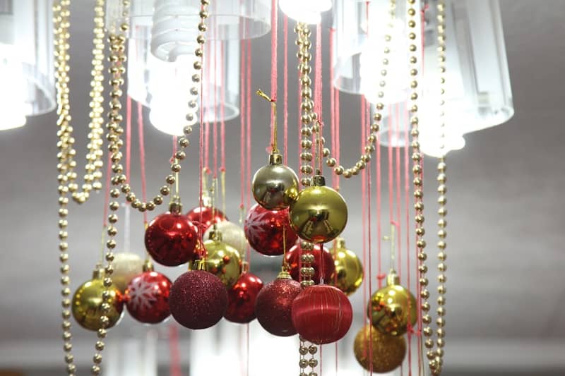 Red and gold christmas ornaments hanging with beads