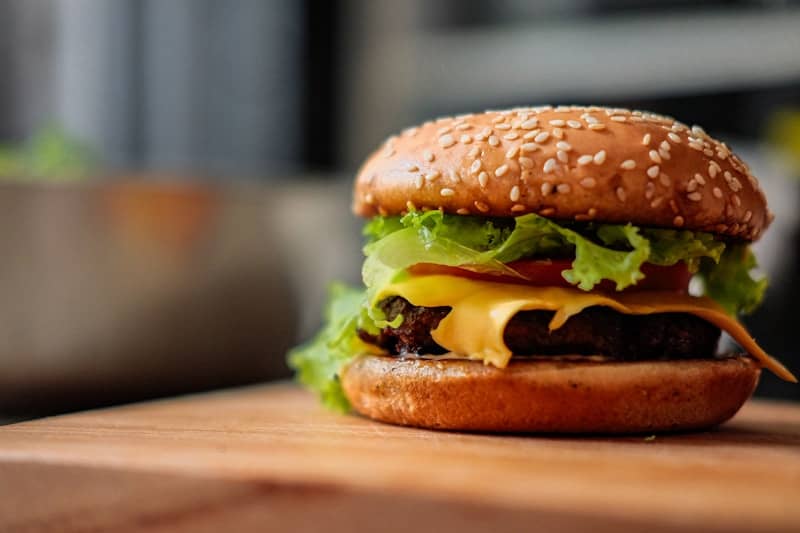 A juicy cheeseburger with lettuce and tomato.