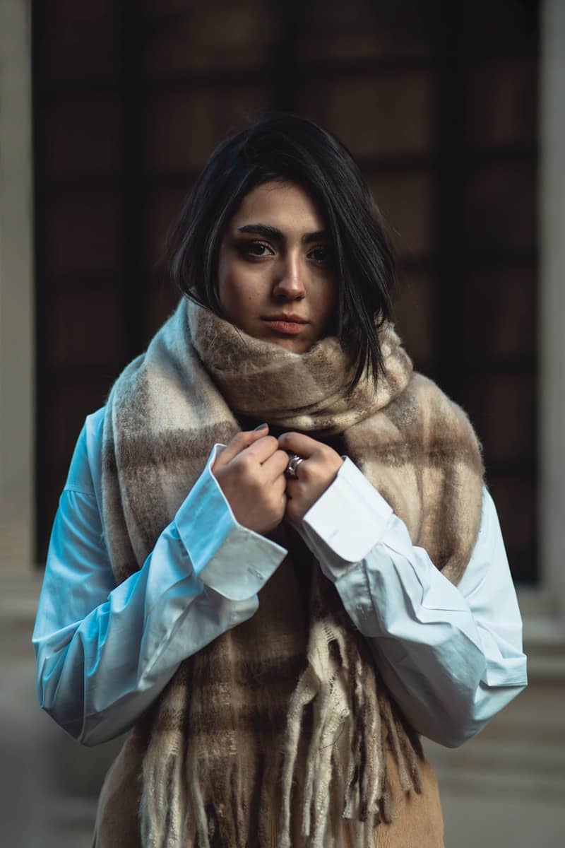 Young woman wearing a warm scarf and white shirt