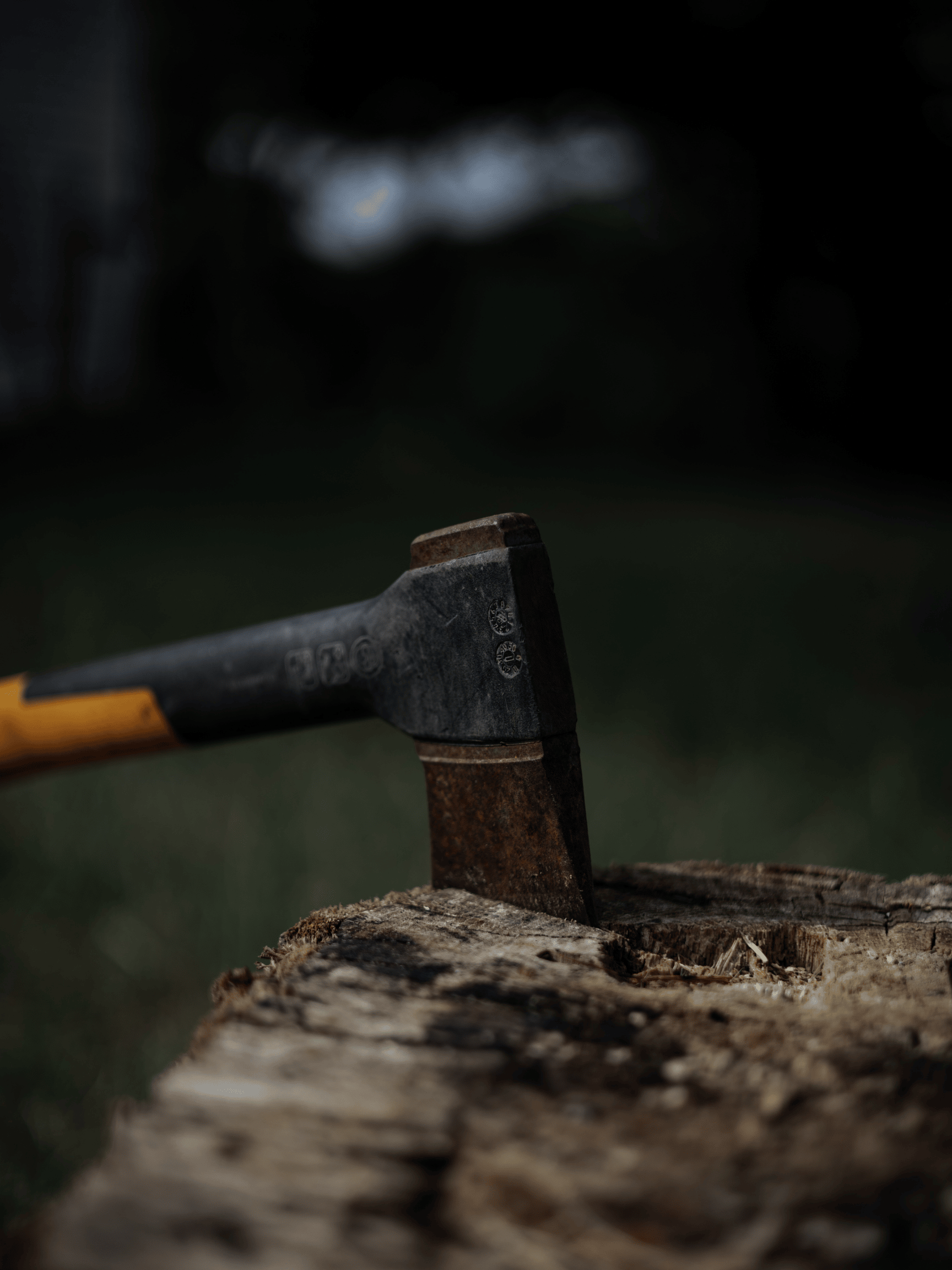 A hatchet in a piece of wood.