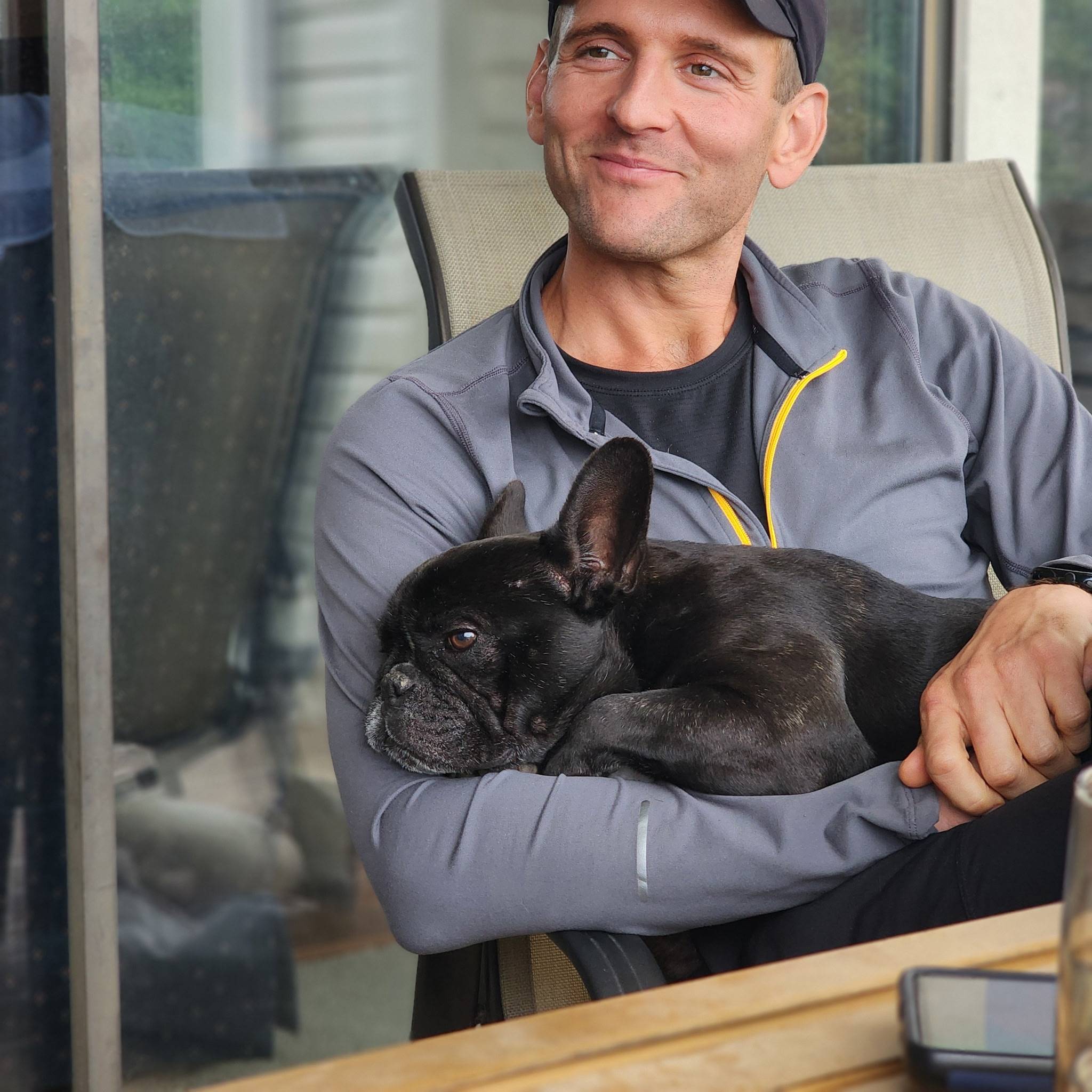 Kaleb Wyse holding Kip smiling.