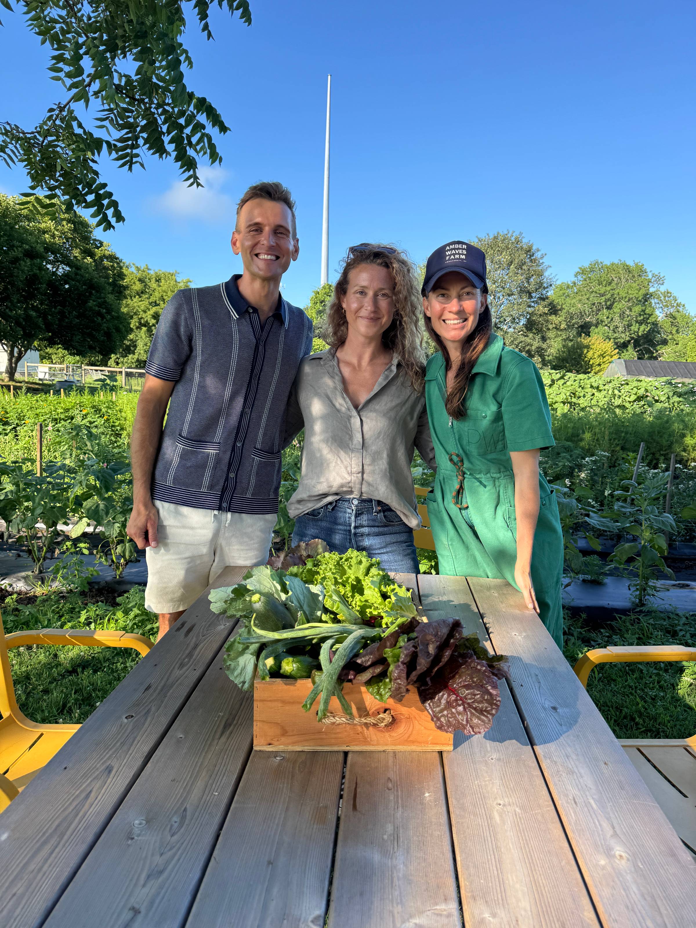 Kaleb Wyse standing with Amanda and Katie of Amber Waves Farm.