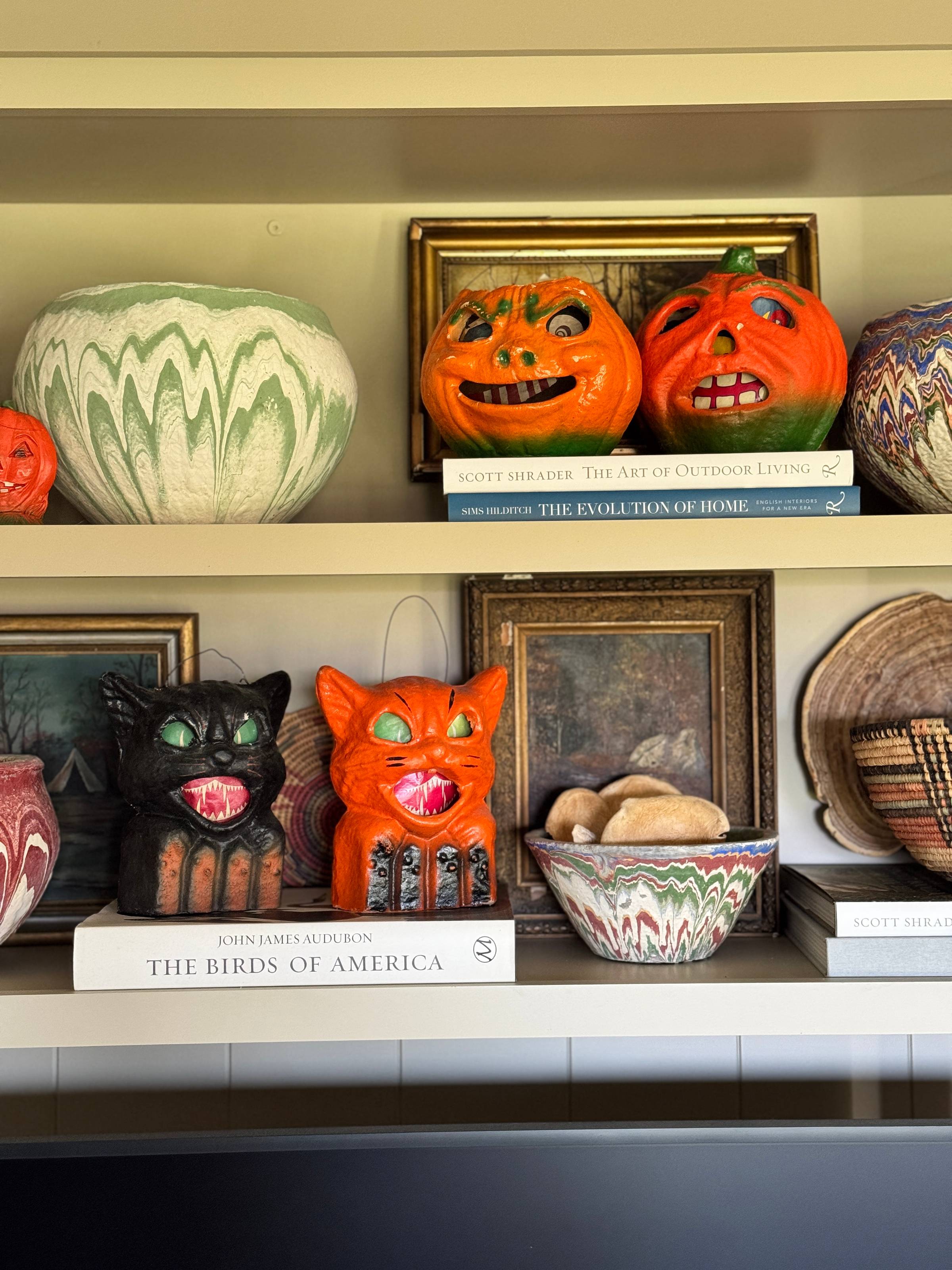 Halloween decor on shelf above a TV.