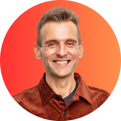 Kaleb Wyse standing in front of orange to red background.