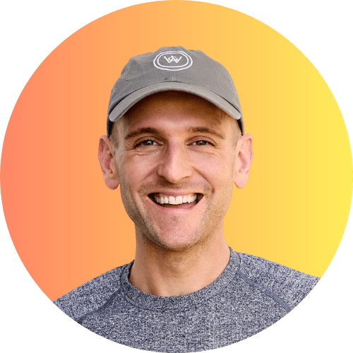 Kaleb Wyse wearing baseball hat standing in front of orange ombre background.