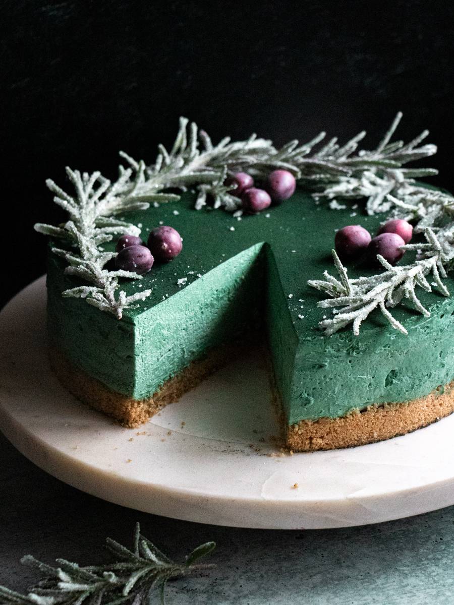 Naturally green spirulina cheesecake topped with sugared rosemary and cranberries.