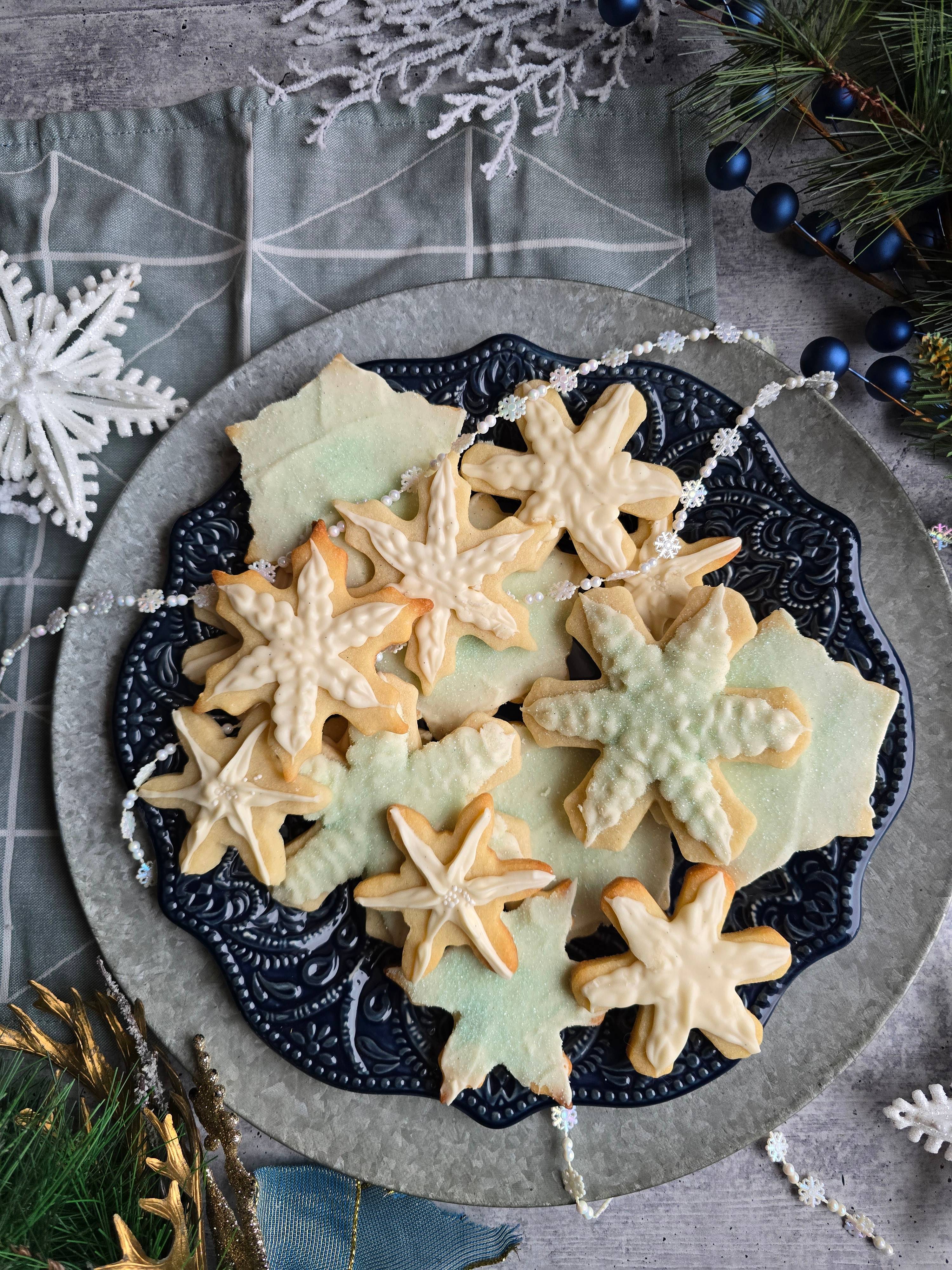 Snowflake theme sugar cookie cut-outs with cream cheese frosting.