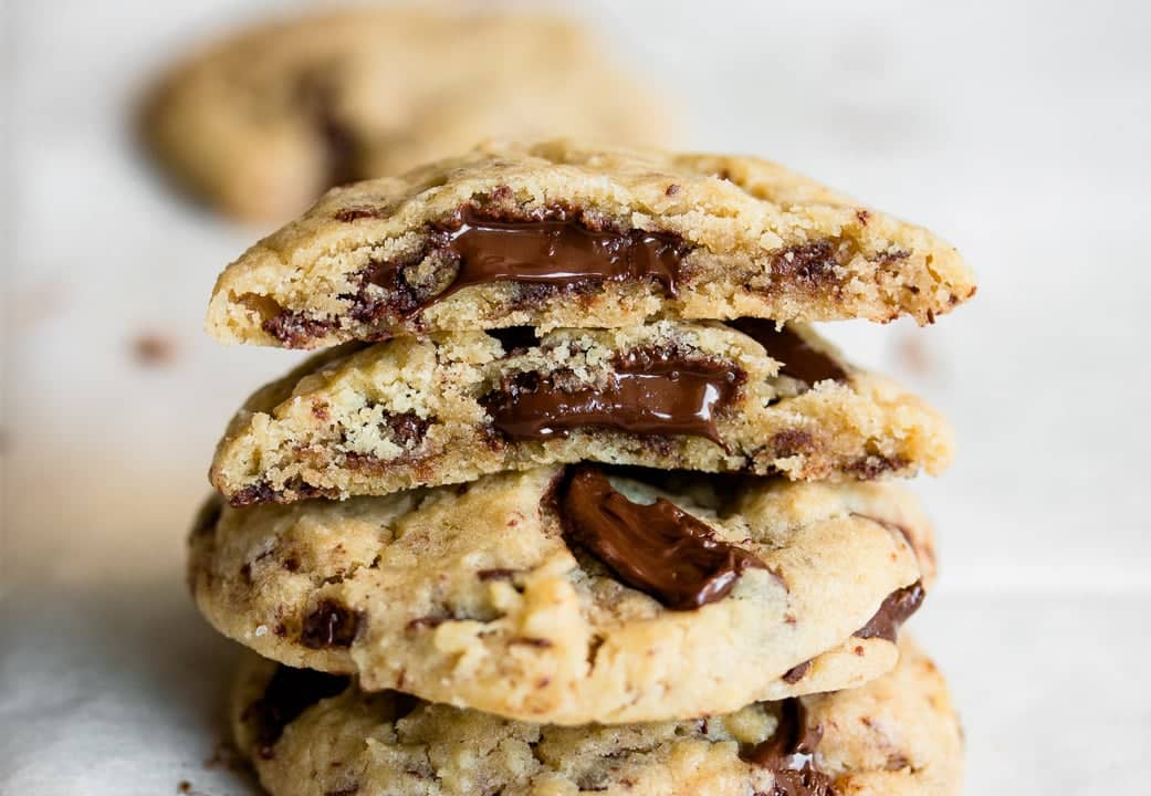 Brown butter chocolate chip cookies with melty bits of chocolate oozing out.