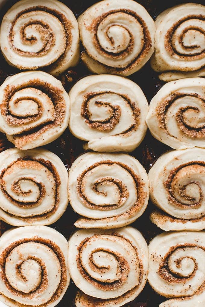 Cinnamon rolls lined neatly in a pan.