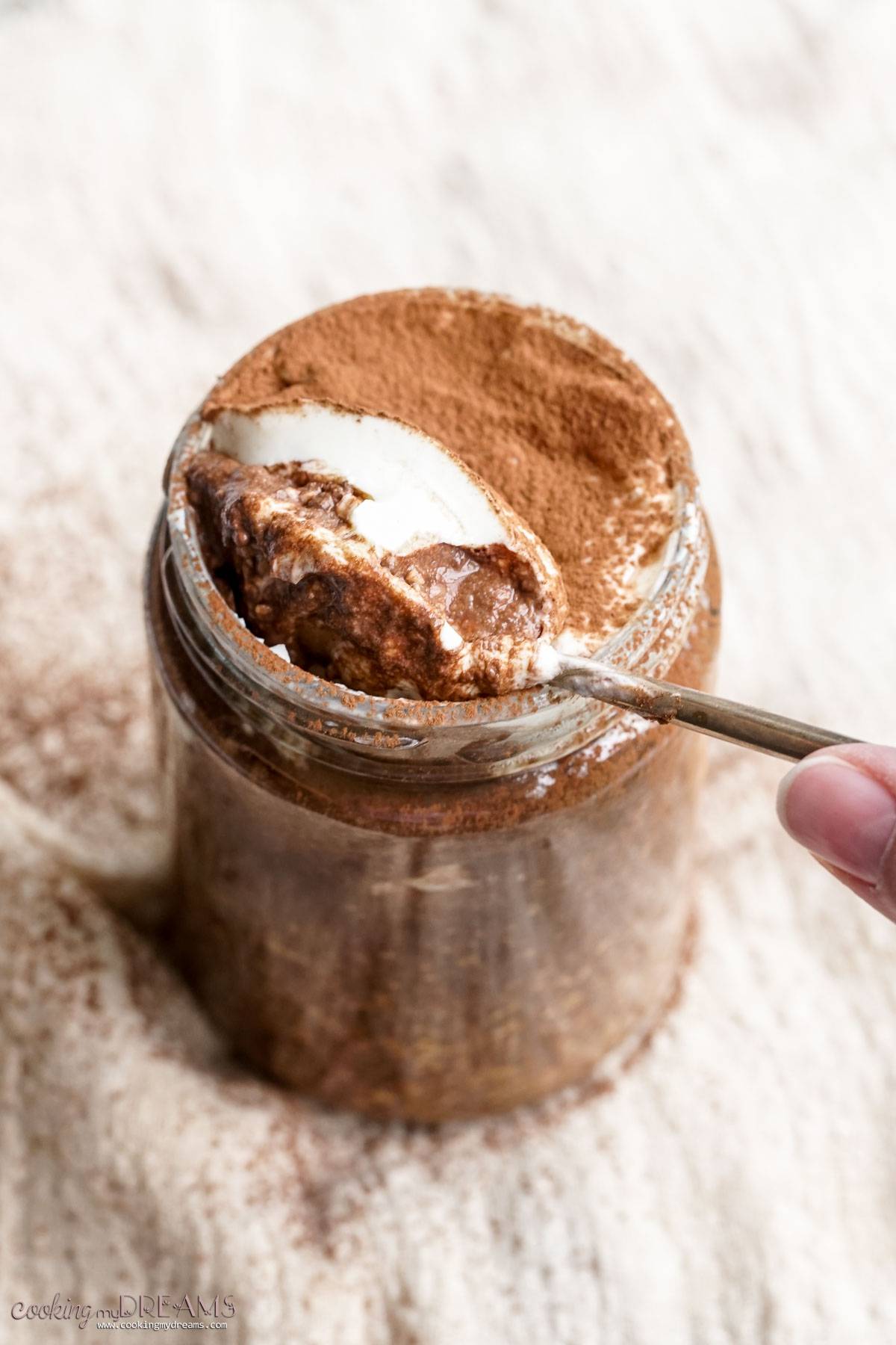 spoon digging into jar of overnight oats