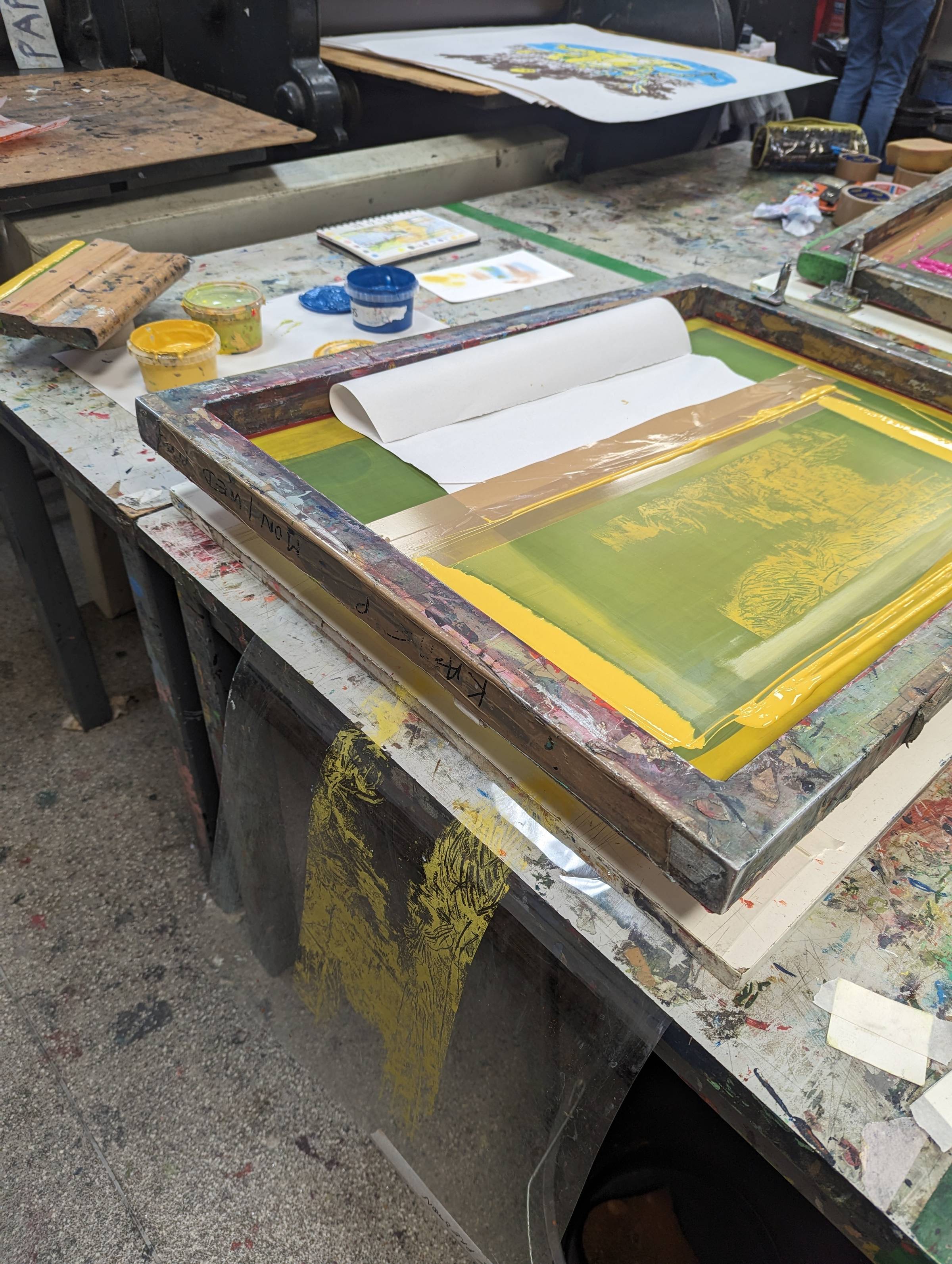 A screenprinting set up with mesh screen and base board