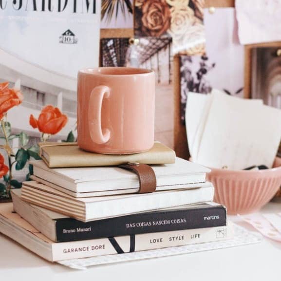 brown ceramic coffee mug on book