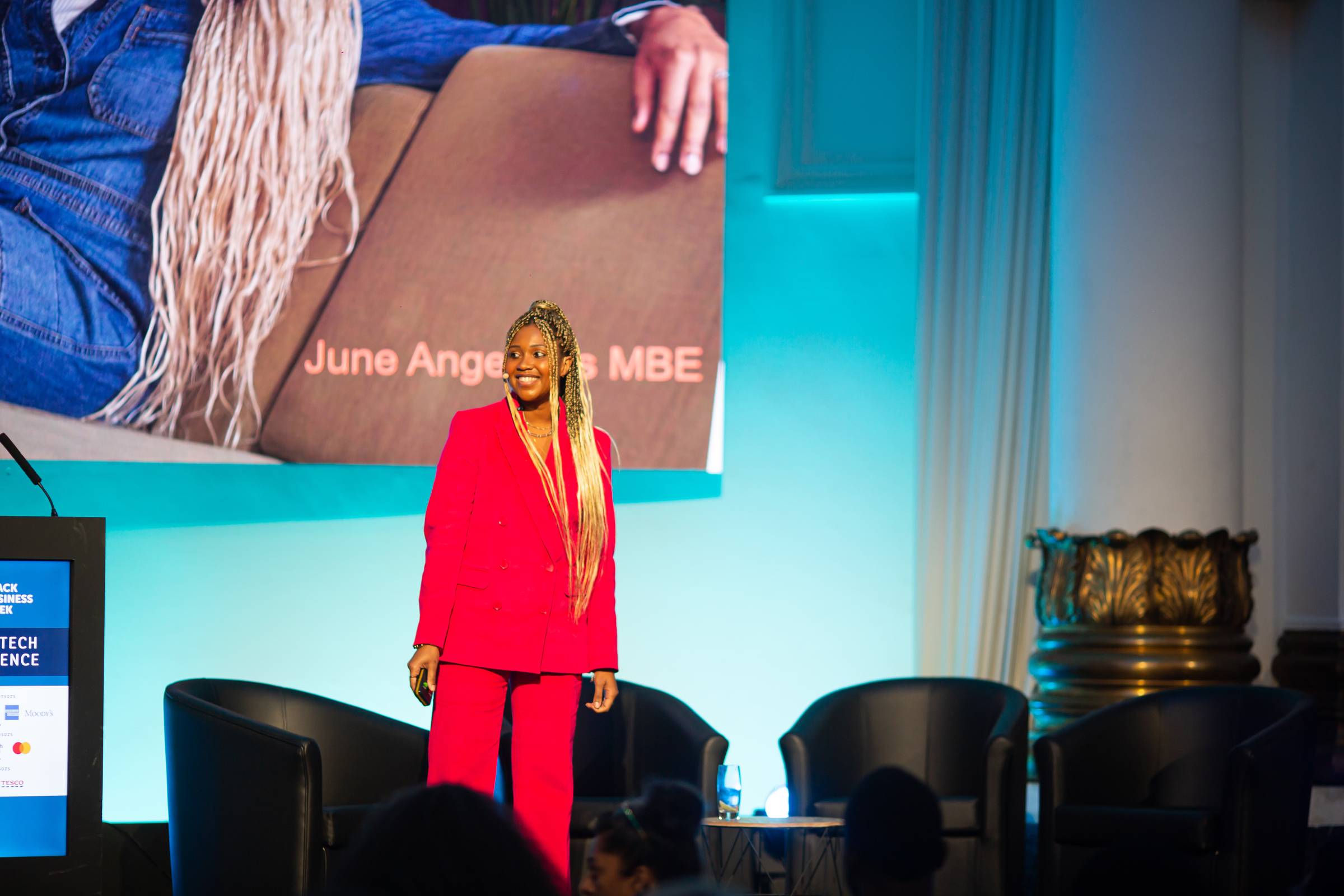 June Angelides speaking at an event, mid conversation, hands raised