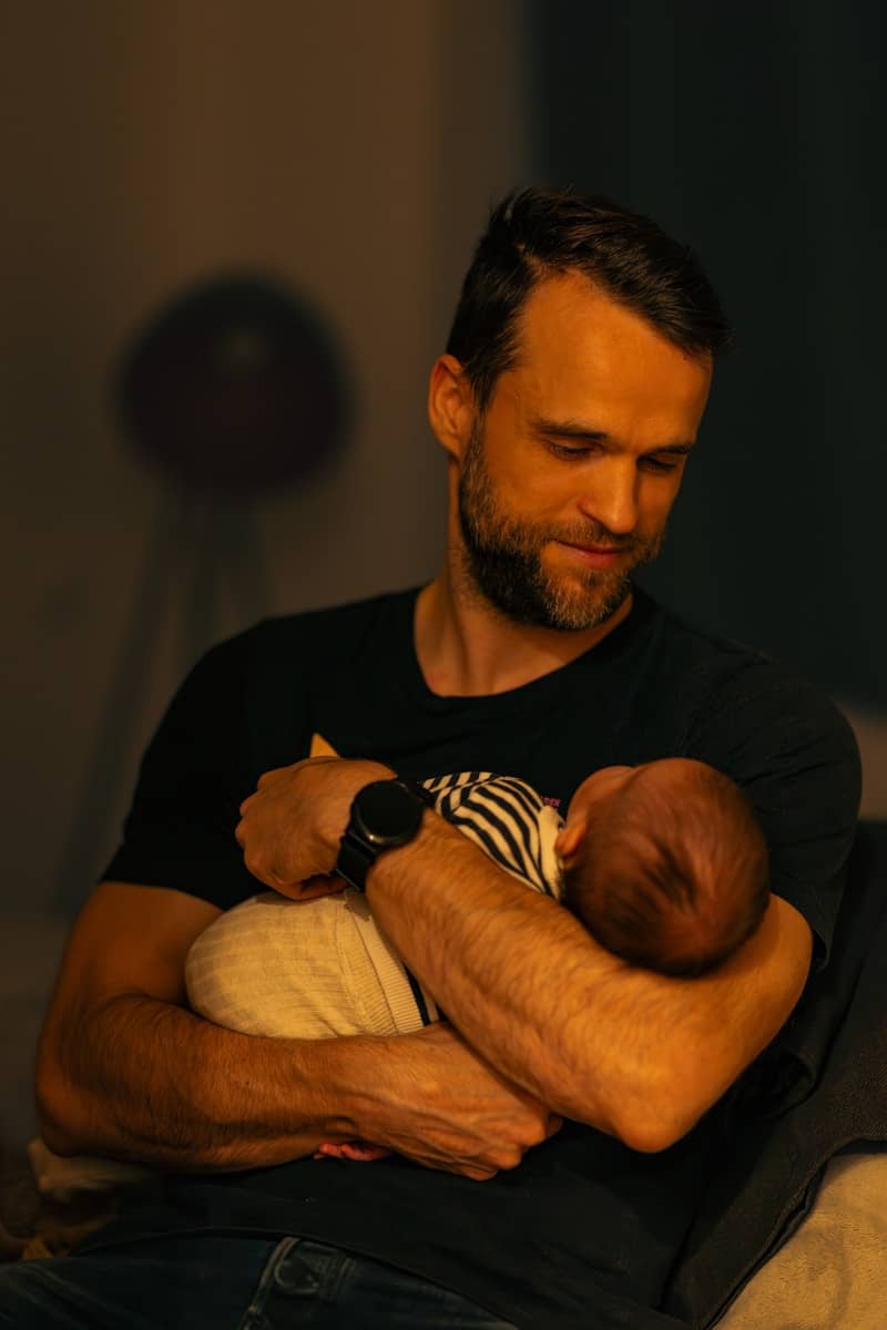 A man holding a baby in his arms