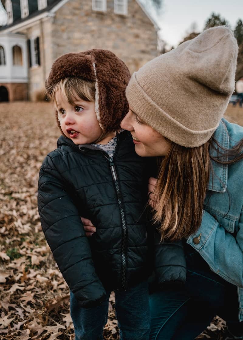 Mother and child in warm hats outdoors