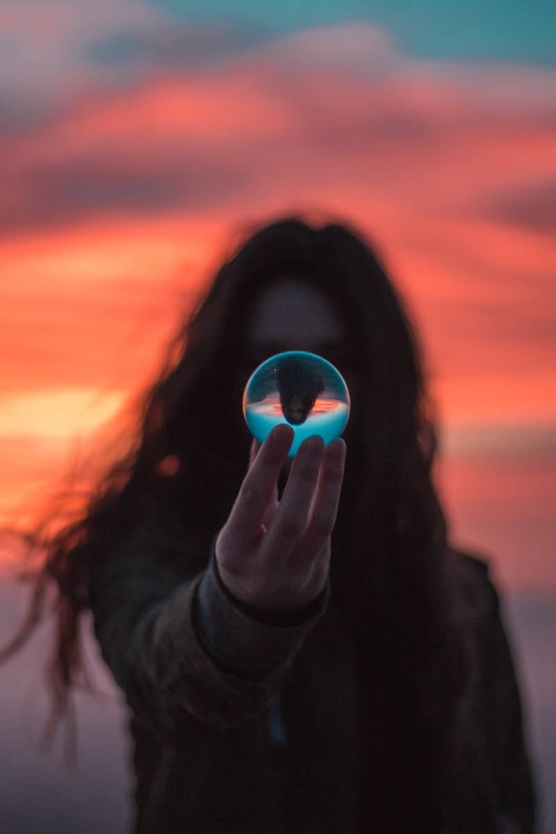 selective focus photography of woman holding ball