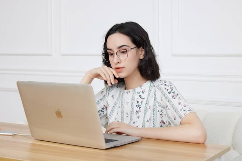 A woman sitting in front of a laptop computer