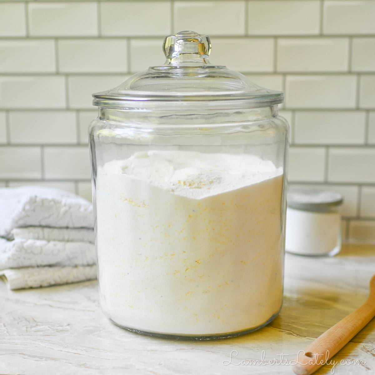 powder laundry detergent in a large glass container.