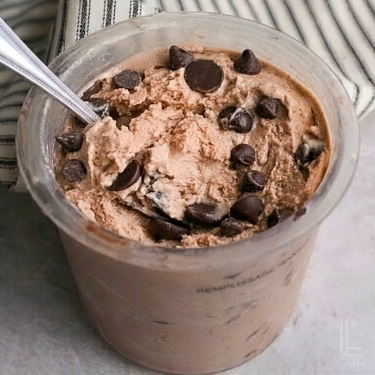 chocolate ice cream covered in chocolate chips in a ninja creami pint container.