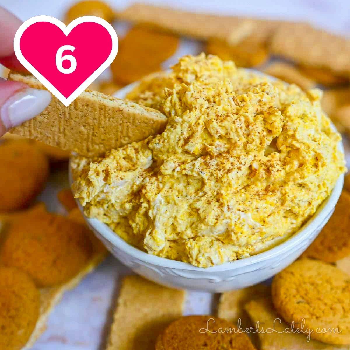 #6 - scooping pumpkin fluff dip with a graham cracker.