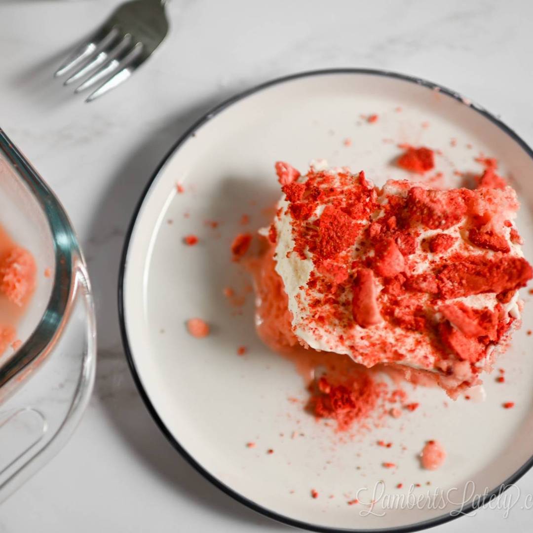 serving of strawberry tres leches cake on a plate.