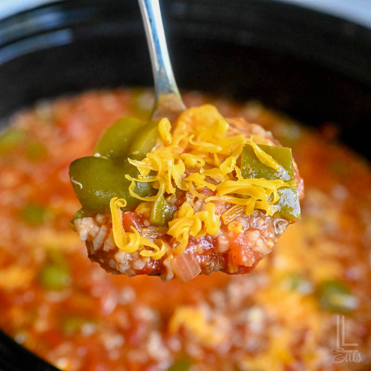 holding a spoonful of stuffed pepper soup.