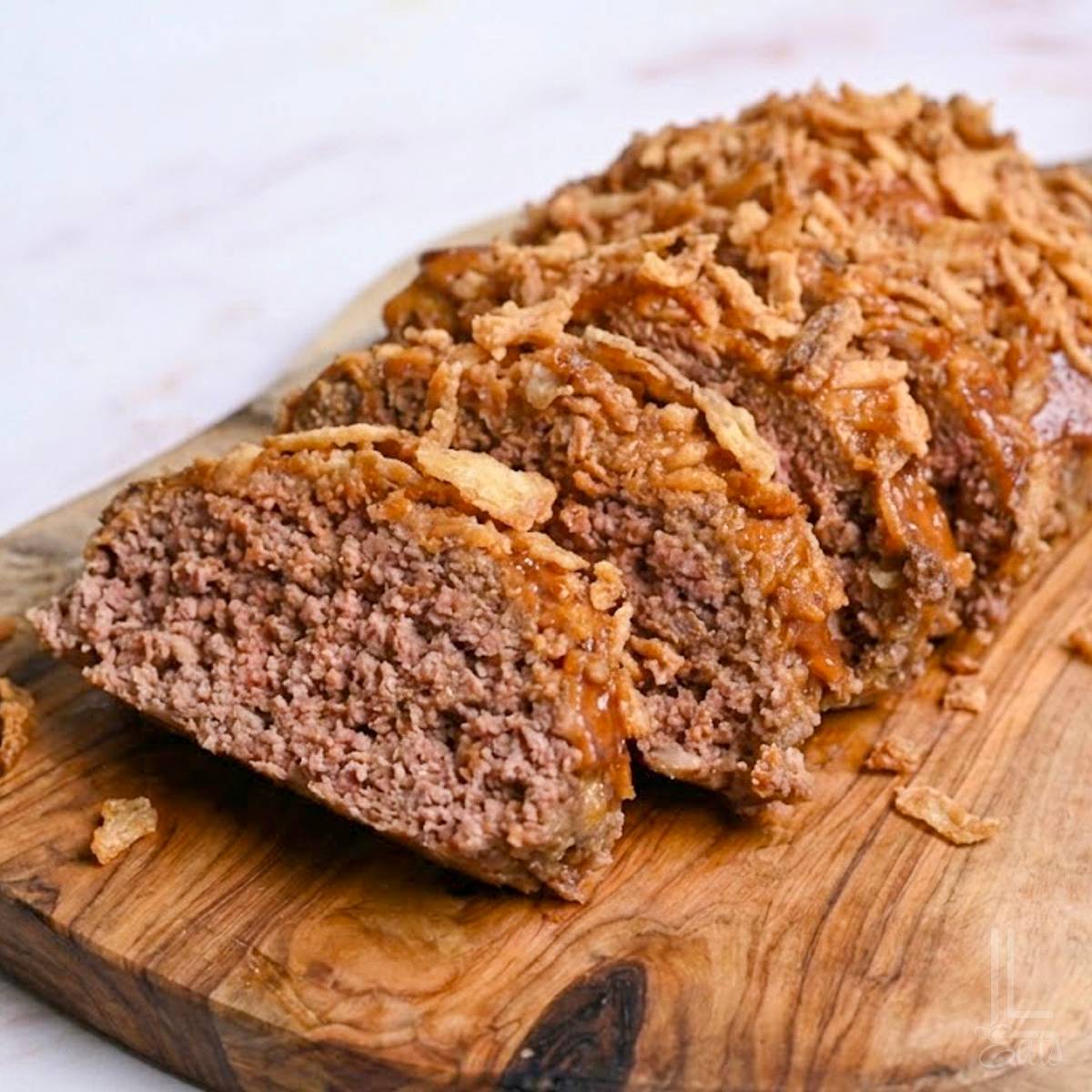 onion soup meatloaf on a cutting board.