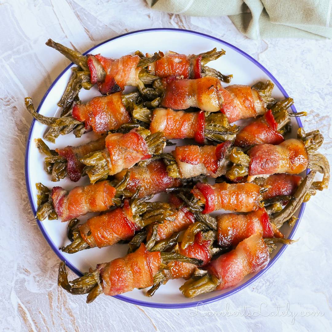 Bacon-wrapped green bean bundles arranged on a serving plate.