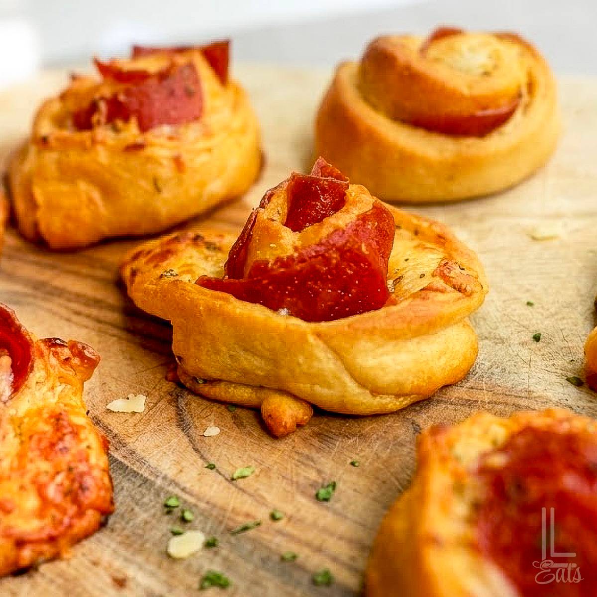 pizza roll ups on a cutting board.