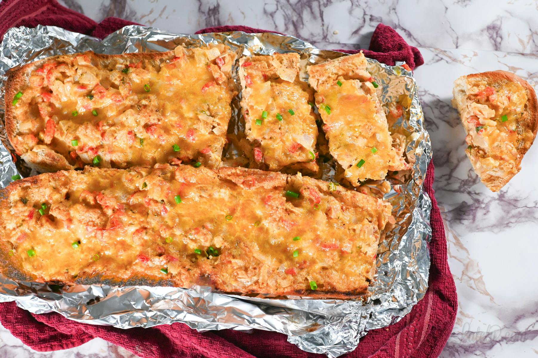 crawfish bread loaf on a sheet of aluminum foil.