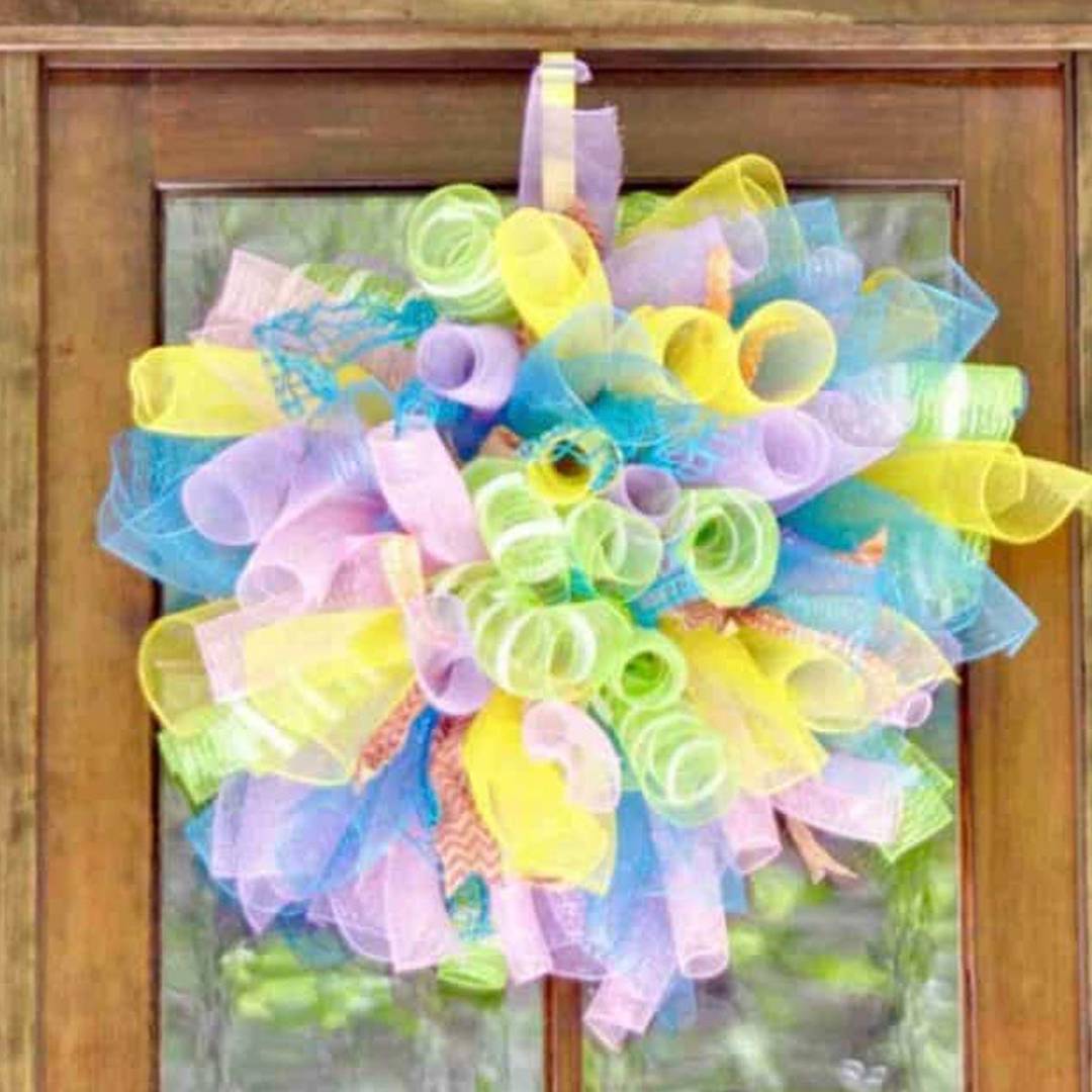 colorful mesh wreath hanging on a door.