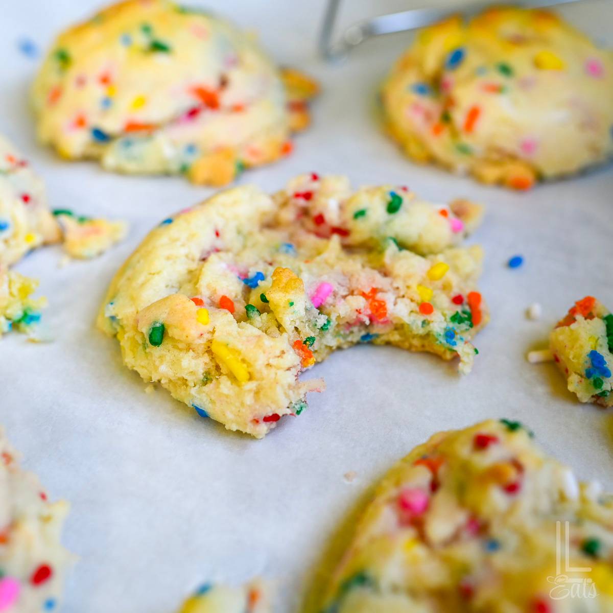 funfetti cake mix cookies with bite taken out.