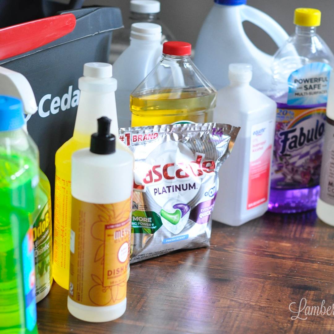 various mop cleaning products in front of a mop bucket.