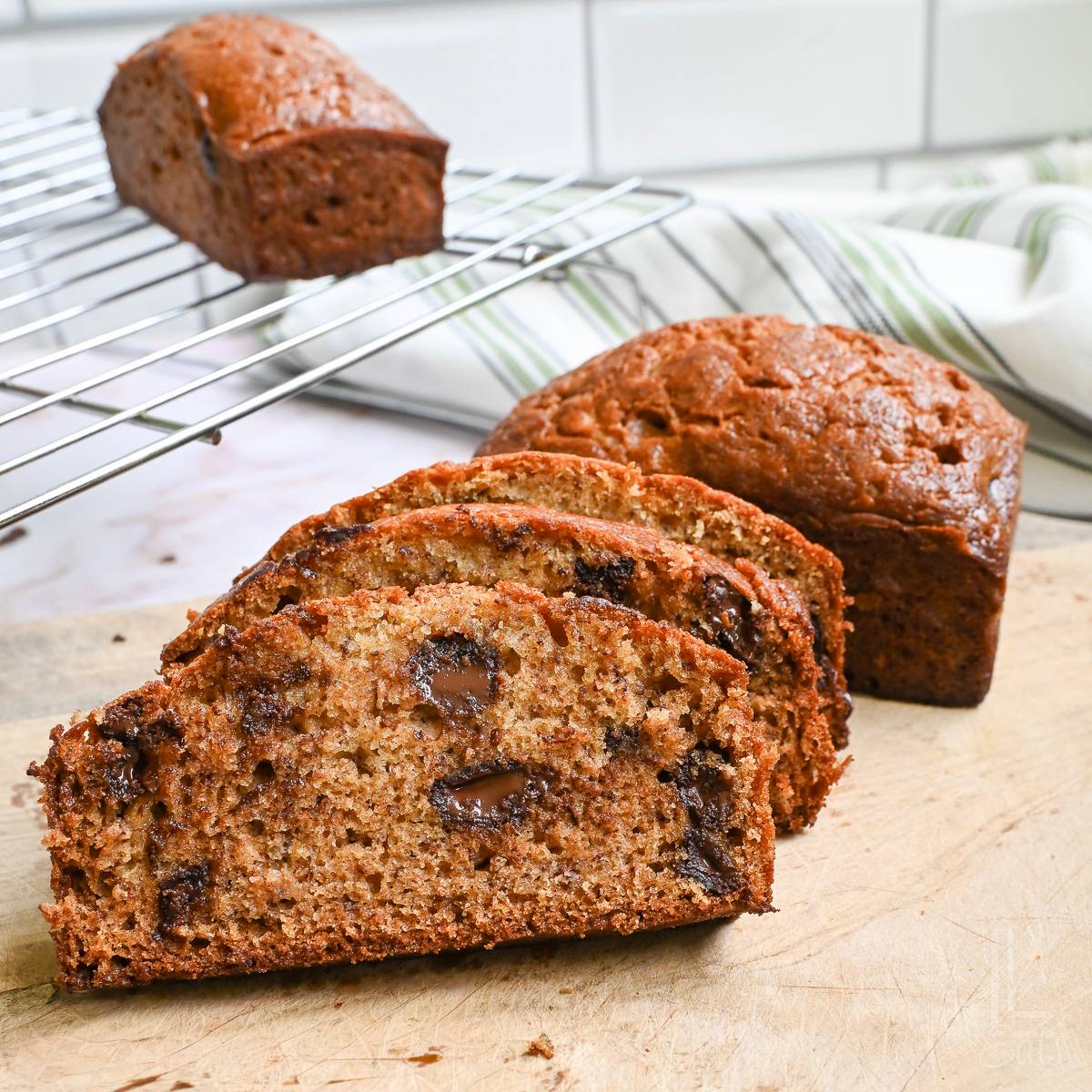 sliced chocolate chip banana bread on a cutting board.