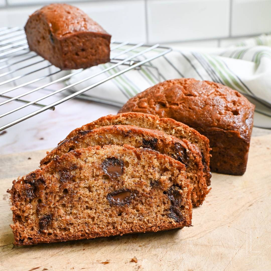 slices of chocolate chip banana bread stacked in a kitchen.