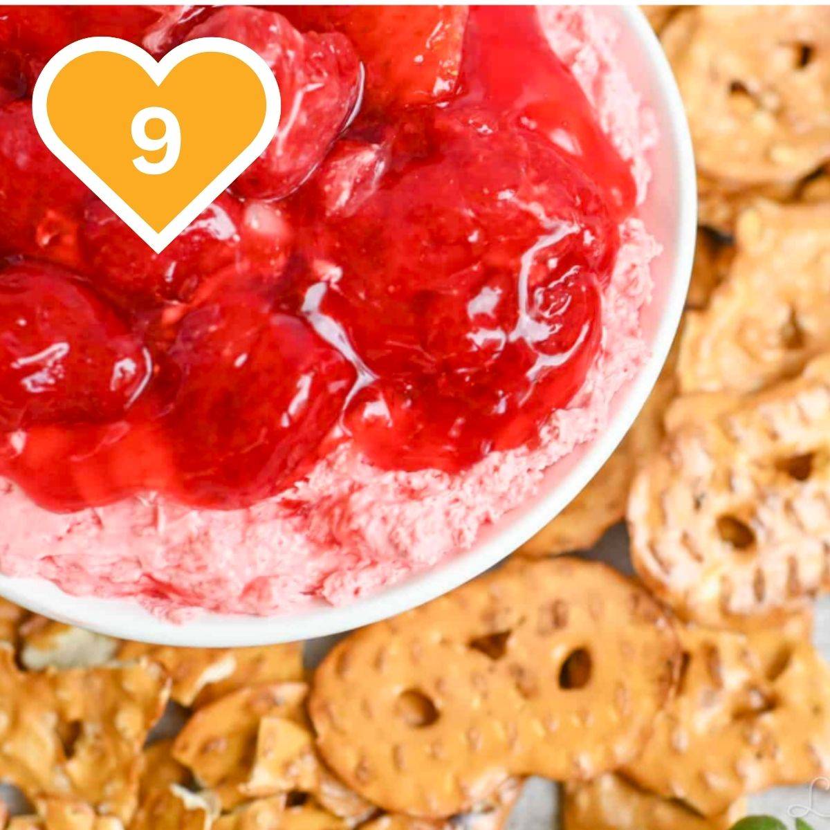 9 - Cream cheese strawberry dip served in a bowl with pretzels or dipping.
