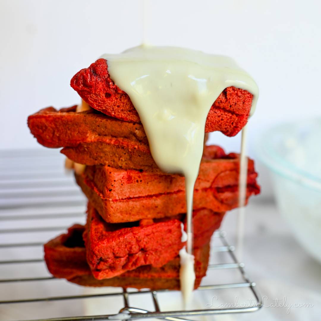 red velvet waffles drizzled with cream cheese frosting.