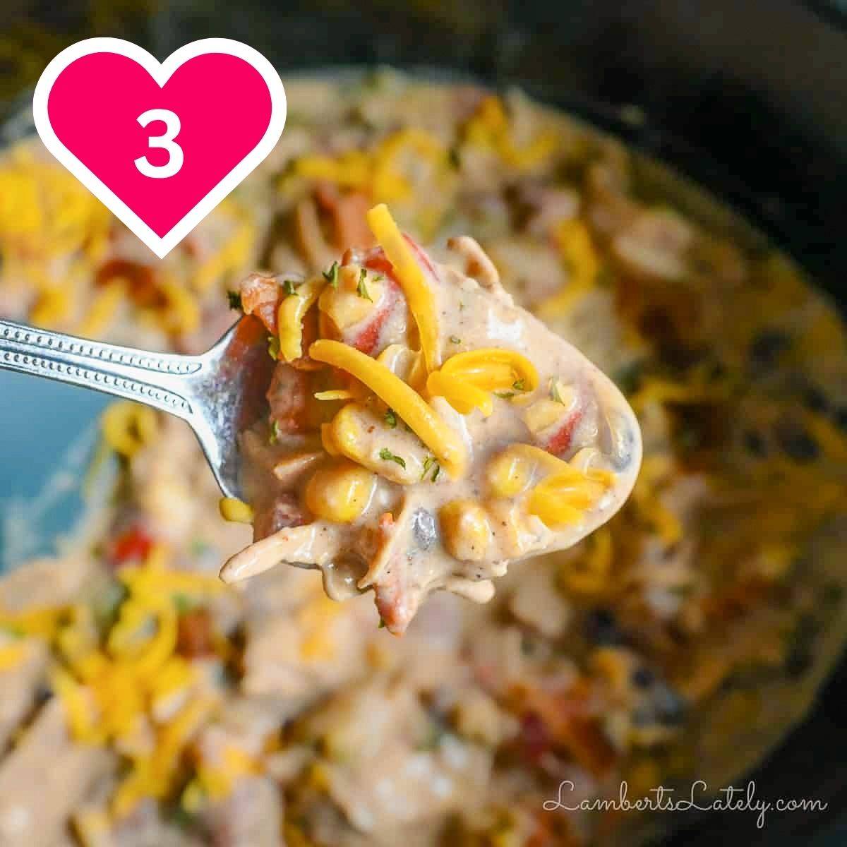 #3 - holding a spoon of crack chicken chili above a crock pot.