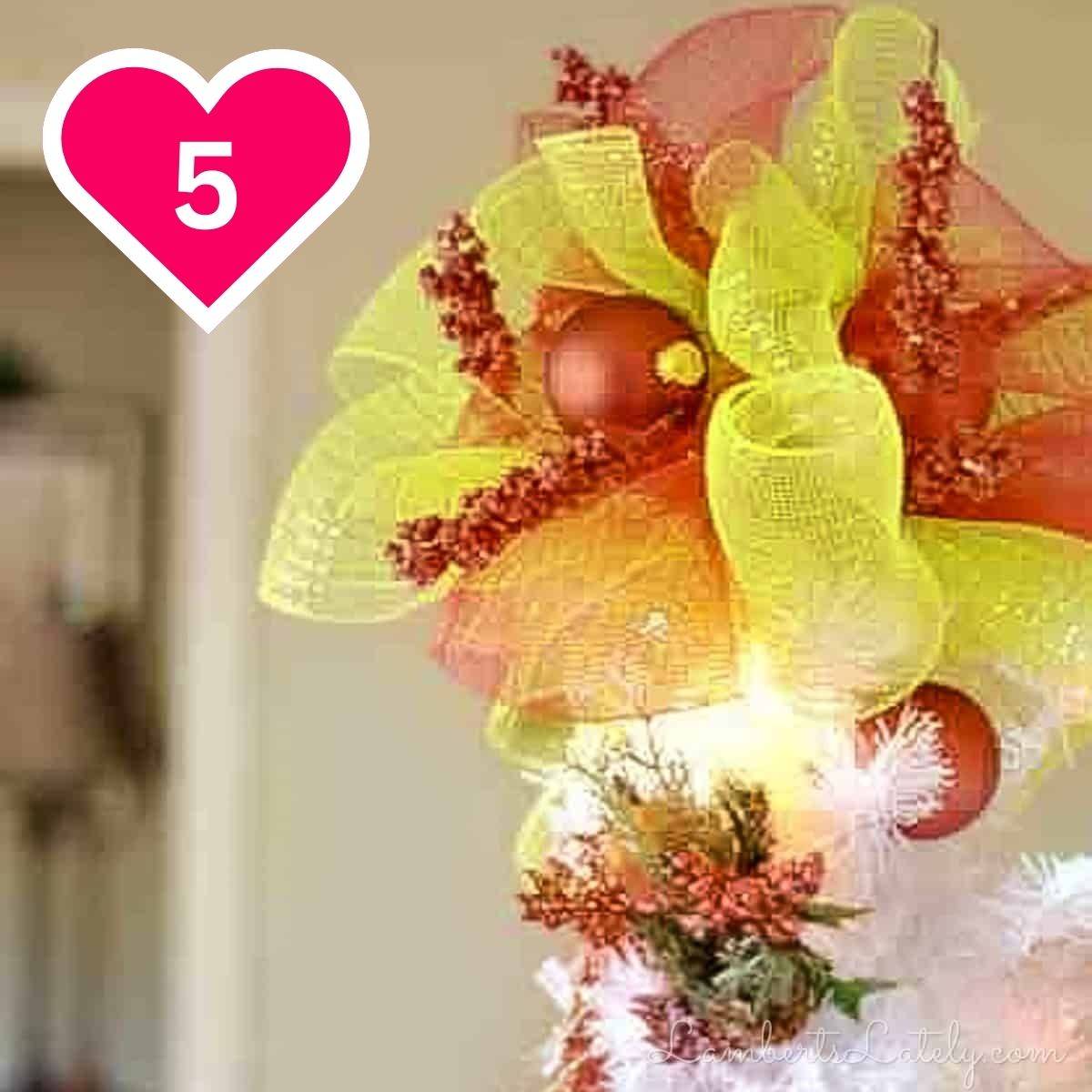 5 - deco mesh tree topper on a white tree.