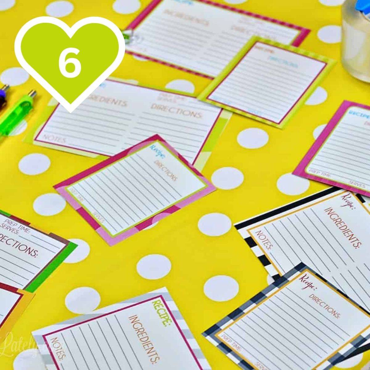Flatlay of printable recipe cards displayed on a yellow polka dot background.