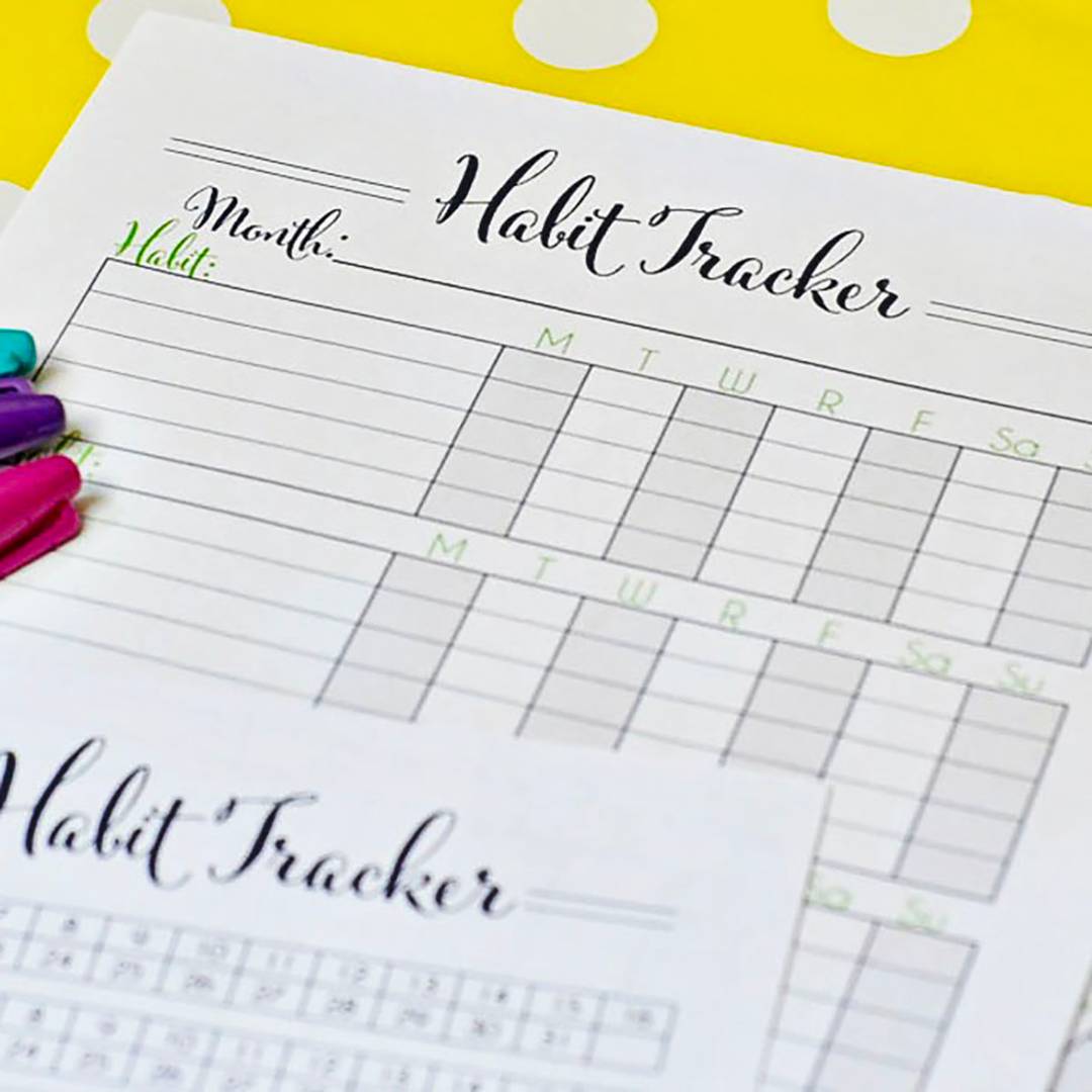 habit tracker printables next to markers.