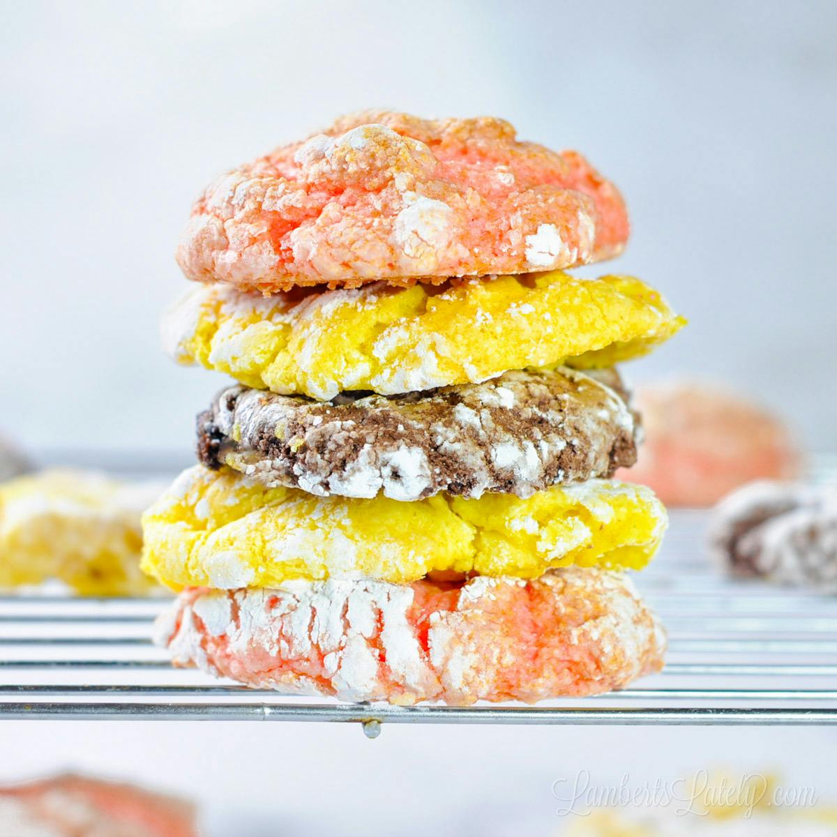 cool whip cookies stacked on a baking rack.