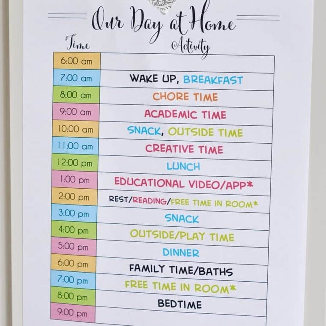 printable at home schedule taped to a wall.