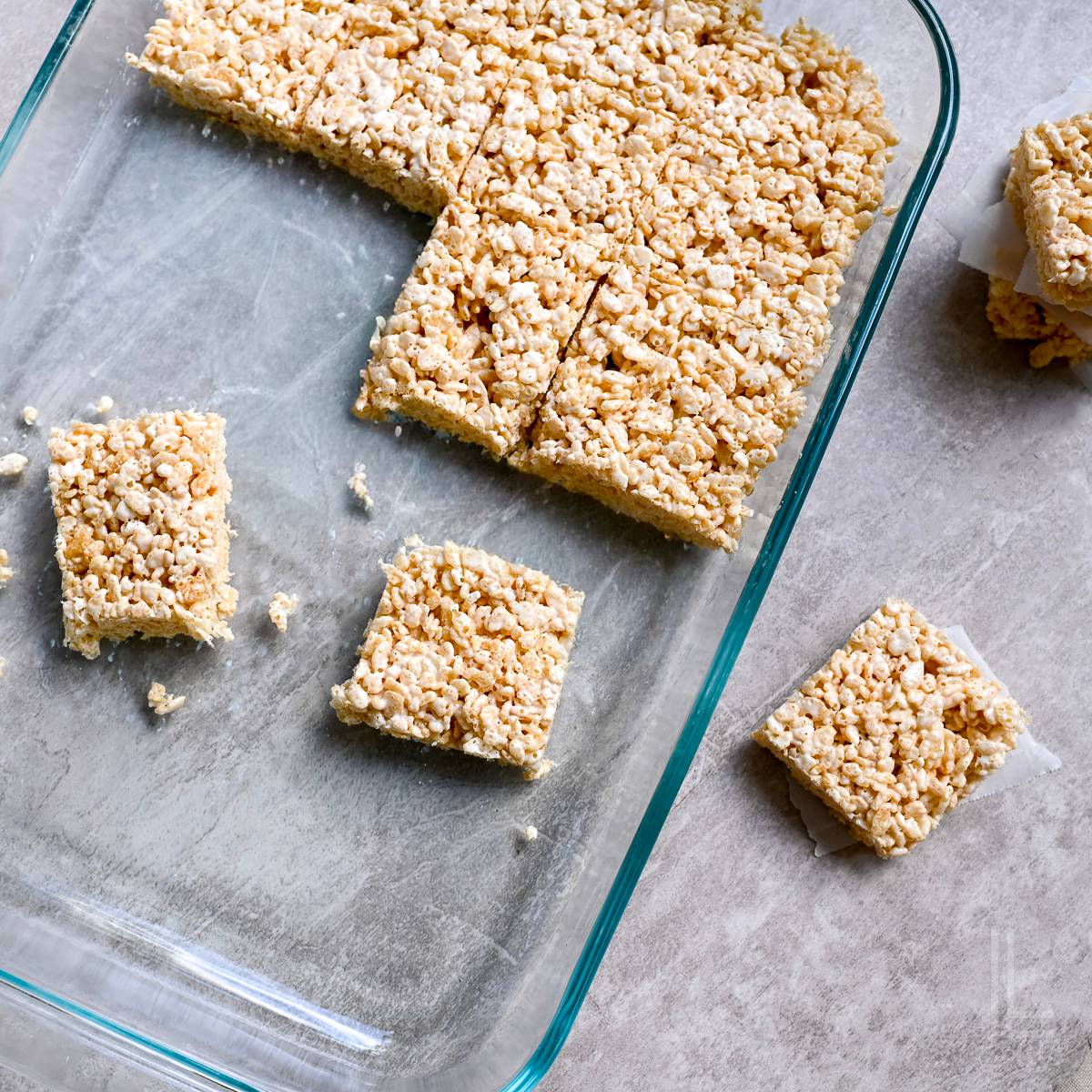 rice krispie treats cut in a baking dish.