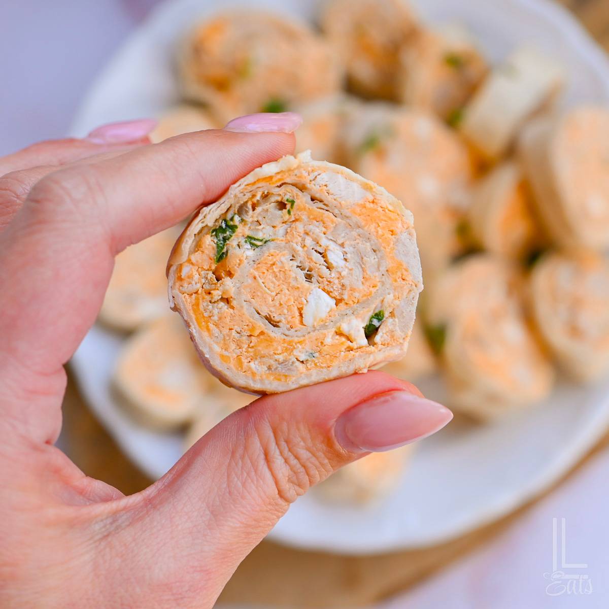 holding a buffalo chicken pinwheel.